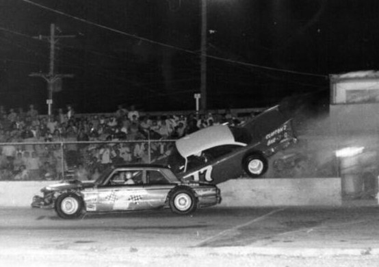 1970 - Dale Mixon rides the wall as Pete Leufkins tries to avoid___.jpg